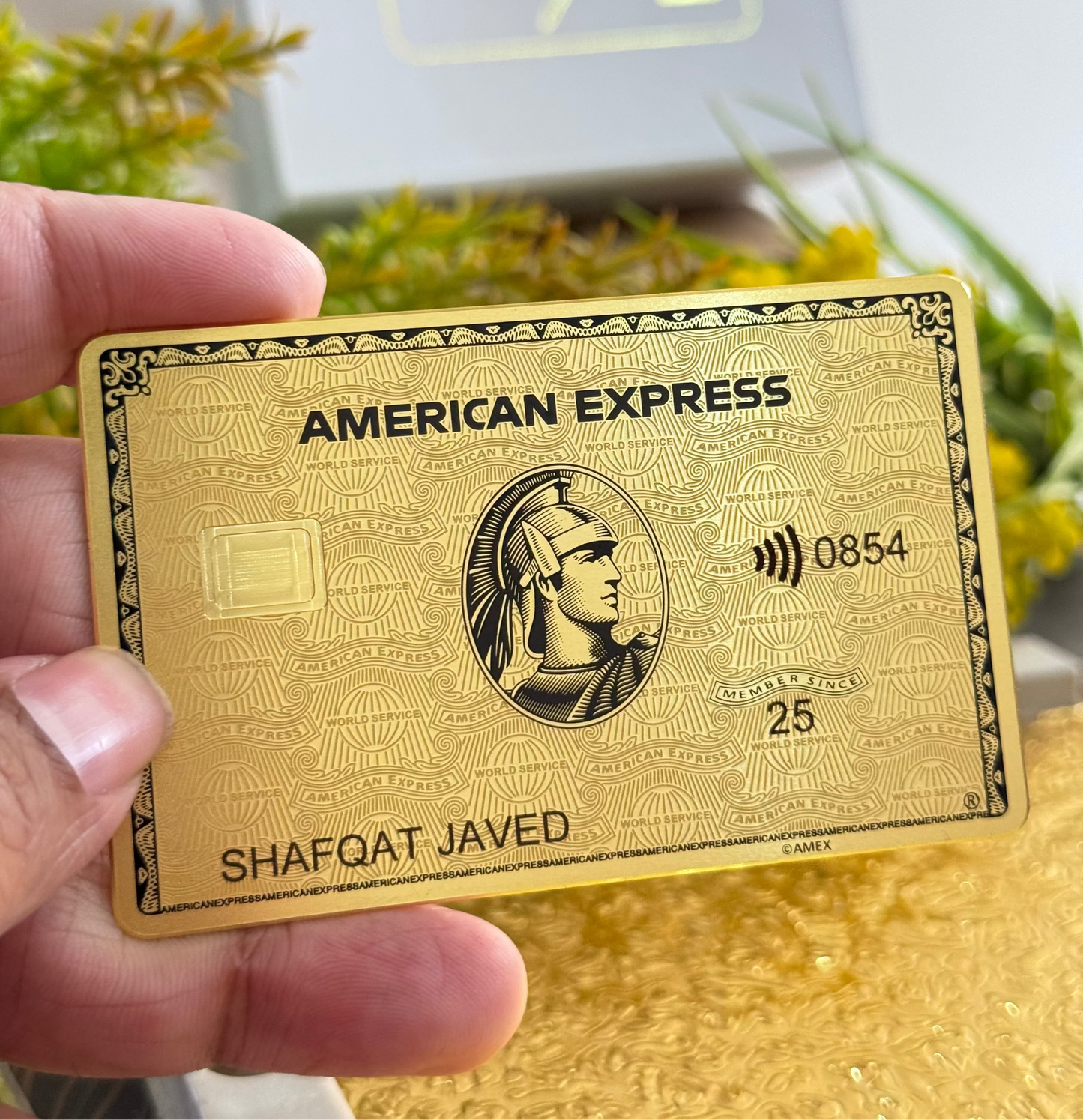 Angled view of Gold Amex metal card by Gold Wraps, showcasing premium custom metal card design