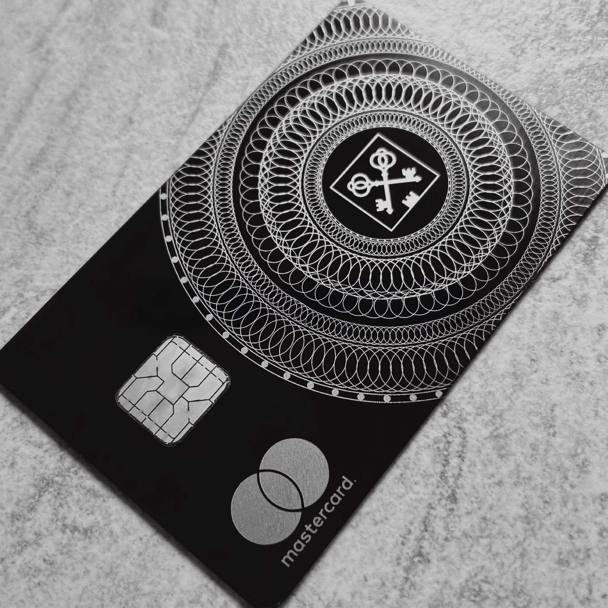 Elite Goldman Lampe black metal card with intricate engraved detailing for luxury branding