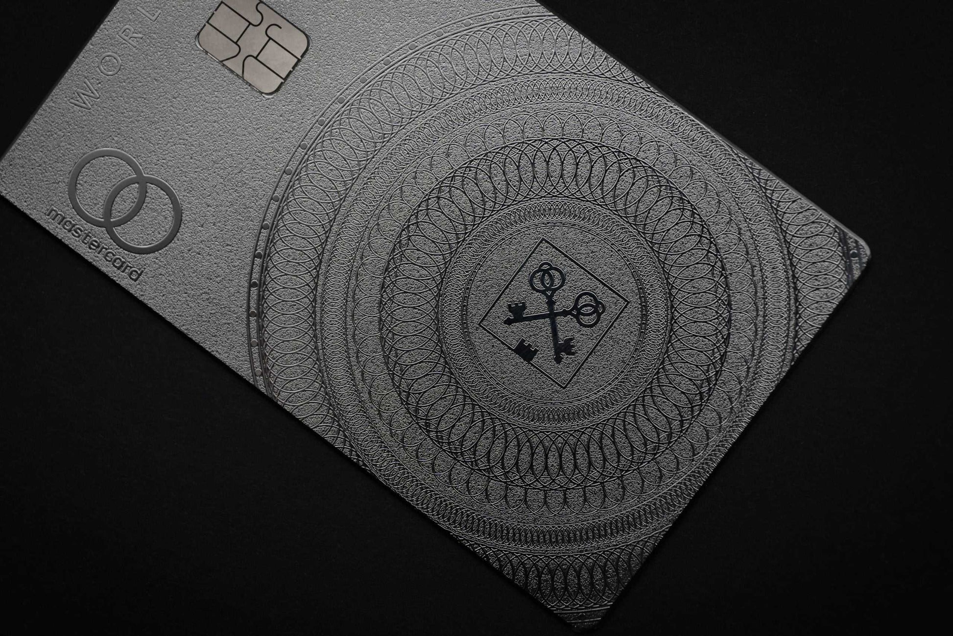 Elite Goldman Lampe silver metal card with intricate engraved silver detailing for luxury branding